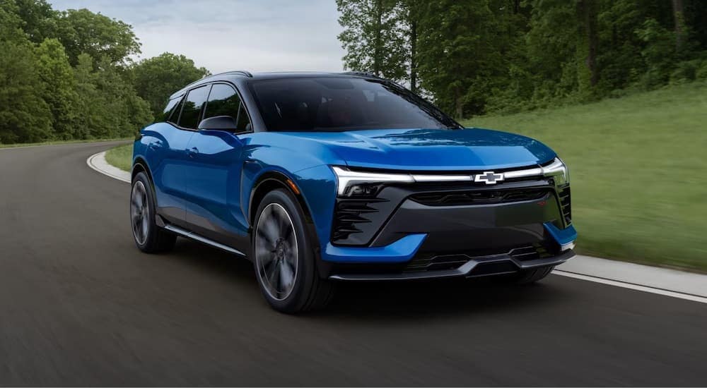 A blue 2024 Chevy Blazer is shown driving.