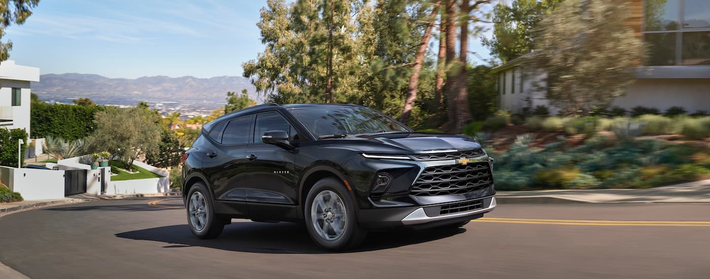 A grey 2023 Chevy Blazer is shown from the front at an angle on a city street after leaving a Chevy dealer near Ann Arbor.